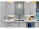 Modern kitchen features white shaker cabinets and a sleek backsplash at 717 Ocean Shore Blvd, Ormond Beach, FL 32176