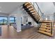 Modern staircase with wooden steps and glass railings, offering ocean views at 717 Ocean Shore Blvd, Ormond Beach, FL 32176