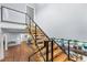 Modern floating staircase with glass and wood accents at 717 Ocean Shore Blvd, Ormond Beach, FL 32176