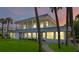 Two-story home with a covered porch, ocean views, and lush lawn at 717 Ocean Shore Blvd, Ormond Beach, FL 32176