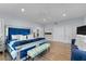 Main bedroom with large blue velvet bed and bench at 717 Ocean Shore Blvd, Ormond Beach, FL 32176