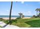Expansive grassy backyard with direct beach access at 717 Ocean Shore Blvd, Ormond Beach, FL 32176