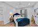 Cozy bedroom with a blue velvet bed frame and hardwood floors at 717 Ocean Shore Blvd, Ormond Beach, FL 32176