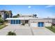 Modern beachfront home with blue garage doors at 717 Ocean Shore Blvd, Ormond Beach, FL 32176