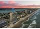 Aerial view of beachfront high-rise building at sunset at 3425 S Atlantic Ave # 1105, Daytona Beach Shores, FL 32118