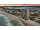 Aerial view of beachfront high-rise building at sunset at 3425 S Atlantic Ave # 1105, Daytona Beach Shores, FL 32118