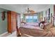 Main bedroom with a king-size bed, ocean view, and armoire at 3425 S Atlantic Ave # 1105, Daytona Beach Shores, FL 32118