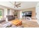 Open living room showcasing a stone fireplace and sliding glass doors at 206 Laurel Point Ct, Deland, FL 32724