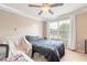 Comfortable bedroom with ceiling fan, large window, and ample closet space at 206 Laurel Point Ct, Deland, FL 32724