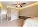 Spacious bedroom with double doors, ceiling fan, and carpeted floor at 206 Laurel Point Ct, Deland, FL 32724