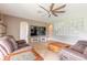 Living room with large screen TV and cozy seating area at 206 Laurel Point Ct, Deland, FL 32724