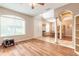 Living room with wood flooring, high ceilings, and view of dining area at 206 Laurel Point Ct, Deland, FL 32724