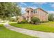 Two story house with brick driveway and landscaped yard at 206 Laurel Point Ct, Deland, FL 32724