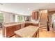 Open kitchen with a large island, granite countertops and stairs at 206 Laurel Point Ct, Deland, FL 32724