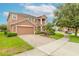 Two story house with brick driveway and landscaped yard at 206 Laurel Point Ct, Deland, FL 32724