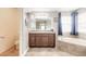 Bright bathroom with vanity, toilet, and corner bathtub at 206 Laurel Point Ct, Deland, FL 32724