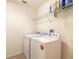 Laundry room with washer, dryer, and shelving at 206 Laurel Point Ct, Deland, FL 32724