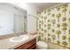 Clean bathroom with a shower/tub combo and palm-tree shower curtain at 206 Laurel Point Ct, Deland, FL 32724