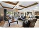 Open living room with leather sectional, coffered ceiling, and view of backyard at 2273 Grayling St, Orlando, FL 32820