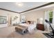 Spacious main bedroom with a king-size bed and an adjoining sitting area at 2273 Grayling St, Orlando, FL 32820
