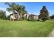 Landscaped front yard with lush grass and palm trees at 2273 Grayling St, Orlando, FL 32820