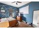 Fun bedroom with blue accent wall and media setup at 2273 Grayling St, Orlando, FL 32820