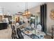 Bright dining room with a glass-top table and seating for six at 2273 Grayling St, Orlando, FL 32820