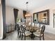 Elegant dining room with glass table, chandelier, and large mirror at 2273 Grayling St, Orlando, FL 32820