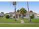 Charming single story home with red tile roof, lush lawn, and palm trees at 133 Cardinal Dr, Ormond Beach, FL 32176