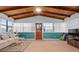 Sunroom addition features wood ceilings, ample natural light, and comfortable seating at 133 Cardinal Dr, Ormond Beach, FL 32176