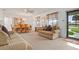 Bright living room features a comfy sofa, dining area, and view of the street at 133 Cardinal Dr, Ormond Beach, FL 32176