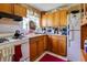 Small kitchen with wood cabinets and gas range at 432 Marion St, Daytona Beach, FL 32114