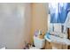 Small bathroom with a toilet, sink, and various toiletries at 432 Marion St, Daytona Beach, FL 32114