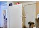 A small kitchen with a refrigerator, cabinets, and a doorway leading to another area at 432 Marion St, Daytona Beach, FL 32114