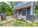 Gray house exterior with a small front porch and a paved patio area at 432 Marion St, Daytona Beach, FL 32114