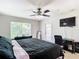 Spacious bedroom with king-size bed, private balcony, and workspace at 561 Majestic Way, Altamonte Springs, FL 32714