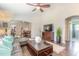 Open living space with hardwood floors, leather sectional, and access to other rooms at 4088 Clock Tower Dr, Port Orange, FL 32129