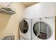 Laundry room with washer, dryer, and ample cabinet space at 4088 Clock Tower Dr, Port Orange, FL 32129