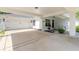 Attached carport with white garage door and ample space at 4088 Clock Tower Dr, Port Orange, FL 32129