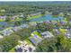 Aerial view of a residential neighborhood with houses, trees, and a lake at 4088 Clock Tower Dr, Port Orange, FL 32129