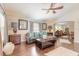 Open concept living area with hardwood floors and a view into the dining area at 4088 Clock Tower Dr, Port Orange, FL 32129