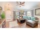 Living room featuring hardwood floors, sectional sofa, and ceiling fan at 4088 Clock Tower Dr, Port Orange, FL 32129