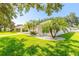 Landscaped yard with lush green grass and palm trees at 4088 Clock Tower Dr, Port Orange, FL 32129