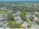 Aerial view of a residential neighborhood with houses, trees, and a lake at 4088 Clock Tower Dr, Port Orange, FL 32129
