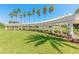 Community entrance with a pergola and palm trees leading to a grassy area at 4088 Clock Tower Dr, Port Orange, FL 32129