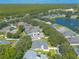Aerial view of a residential neighborhood with houses, trees, and a lake at 4088 Clock Tower Dr, Port Orange, FL 32129