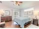 Main bedroom with wood floors,sliding doors to backyard, and ceiling fan at 4088 Clock Tower Dr, Port Orange, FL 32129