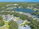 Aerial view of a residential neighborhood with houses, trees, and a lake at 4088 Clock Tower Dr, Port Orange, FL 32129