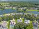Aerial view of a residential neighborhood with houses, trees, and a lake at 4088 Clock Tower Dr, Port Orange, FL 32129