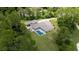 Aerial view showcasing house, pool, and lush greenery at 2075 Country Farms Rd, Port Orange, FL 32128